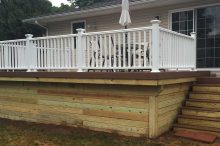 Raised Backyard Deck with White Railings