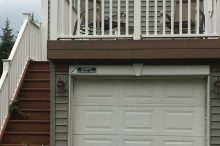Compact Garage with Overhead Deck and Exterior Staircase