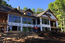 Framing Progress of Large Lakefront Custom Home with Expansive Windows