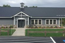 Modern Light Commercial Building with Metal Roof and Stone Accent