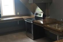 Modern Commercial Kitchenette with Granite Counters