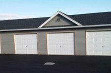Multi-Unit Garage with Four Overhead Doors and Vinyl Siding