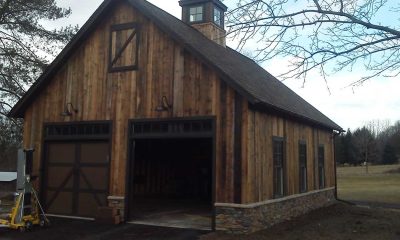 Rustic Barn-Style Garage with Natural Wood Siding and Stone Skirt