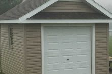Compact Single-Car Garage with Gable Roof and Beige Vinyl Siding