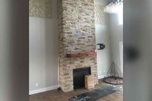 Modern Two-Story Stone Fireplace in New Living Room