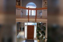 Grand Entry with Walkaround Balcony and Arched Window